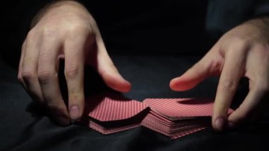 Poker table during the game. The player holds the cards in his hands. Chips and cards on the table. Gambling theme