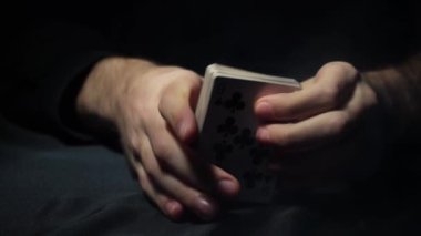 Poker table during the game. The player holds the cards in his hands. Chips and cards on the table. Gambling theme