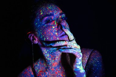 Model woman in neon light, beautiful model girl with fluorescent makeup, art design of disco dancer dancing in uv light, colorful makeup. Nightclub, Party