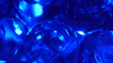 Water color gel balls. Super macro bubbles slow motion. Bubbles of water. Liquid cream gel transparent cosmetic texture sample with bubbles. Background with hydrogel balls with glitter