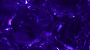 Water color gel balls. Super macro bubbles slow motion. Bubbles of water. Liquid cream gel transparent cosmetic texture sample with bubbles. Background with hydrogel balls with glitter