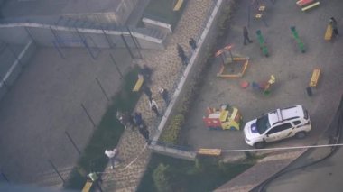 Kyiv, Ukraine - November 15, 2022: Consequences of an extinguished fire. Courtyard of a high-rise residential building. Residents watch as they put out the fire