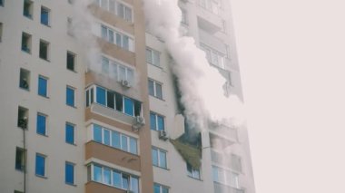 Kyiv, Ukraine - November 15, 2022: A group of firefighters stands on the balcony of an apartment building discussing a plan of action. Putting out a fire in an apartment building