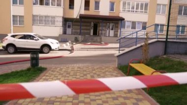 Kyiv, Ukraine - November 15, 2022: Ribbon denoting dangerous territory. Consequences of an extinguished fire. Courtyard of a high-rise residential building