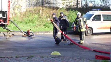 Kyiv, Ukraine - November 15, 2022: Consequences of an extinguished fire. Equipment for stacking fire trucks. High-rise residential building. The concept of completing a dangerous job