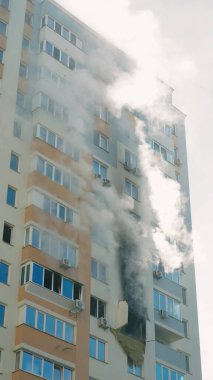 KYIV, UKRAINE - NOVEMBER 15, 2022: Fire in the apartment. Thick gray smoke comes from the windows of an apartment building. Extinguishing a fire in an apartment building. vertical video