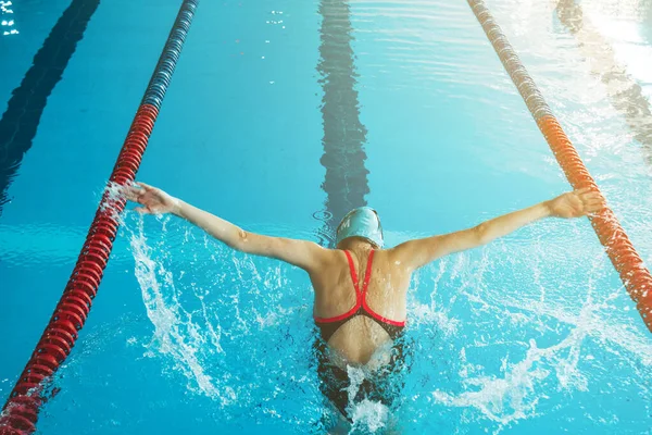 stock image Successful female swimmer swimming in the pool. A professional athlete is determined to win the championship