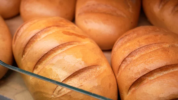 stock image Fresh bread on the shelves of the bakery in the supermarket. Shopping at the grocery store. Selling food concept