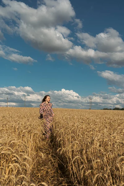 Pray for Ukraine. Ukrainian girl in a wheat field. A girl in a wheat field prays for peace in Ukraine. Happy woman celebrating Independence Day