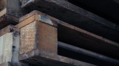 Palet rafı deposu, lojistik merkezi. Kocaman, büyük, modern bir depo. Boş ahşap paletler bir depoya istiflenmiş. Mağazada yığılmış bir sürü boş palet var.