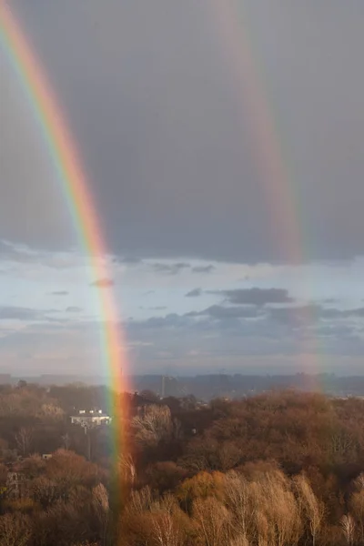Double rainbow against the sunset sky. Leprechaun at the end of the rainbow. Rainbow as a concept of fantastic money. Pot of gold. St.Patrick 's Day