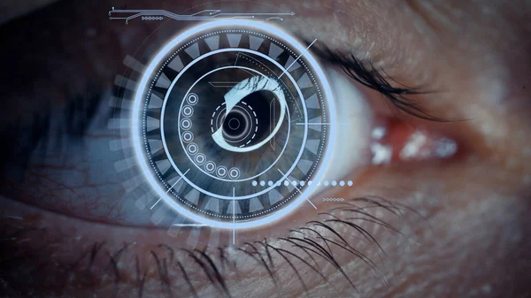 Close-up of a male eye with visual effects. The concept of a sensor implanted in the human eye. Business, computer, cyberspace