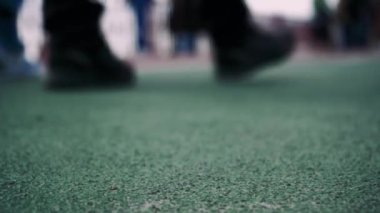 İnsanların yürüdüğü kırmızı bir bisiklet yolu. Bisiklet sürmek için bisiklet yolu. Pistte yürüyen ayaklar, yakın plan. arkaplan videosu