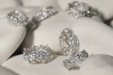 Zümrütler mücevherlere yakın çekim yapar. Elmas değerli taşlı güzel küpeler. Beyaz arka planda, lüks kadın mücevherleri.