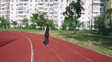 Spor sahası olan bir apartmanın önünde bir kız düşünceye dalıyor. Kentsel yaşam ve tefekkür temaları için ideal
