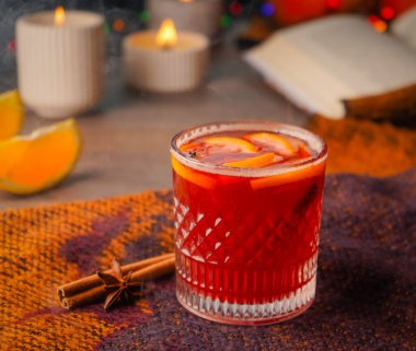 Noel sıcak şarabı baharat ve narenciye dolu bir bardakta. Tarçın, anason ve portakallı sıcak şarap. Noel atmosferi