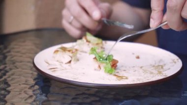 Genç bir adam bir kafe yakınındaki bir sokak terasında kahvaltı yapıyor. Yalnız bir adam küçük cam bir masada kahvaltı yapıyor. Tek bir yaşam teması için mükemmel