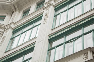 Viyana, Avusturya - 12 Mayıs 2019: Konut binalarının antik mimarisi. Güzel sarayın penceresi. Seçkin bir ev, pencerelerinin yakın plan fotoğrafı. Aşağıdan yukarıya doğru ham pencereler