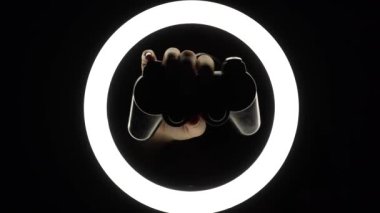 female hands hold a gamepad on a black background. joystick controller for gaming platform close-up. Esports and cybersports concept.