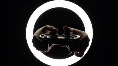 female hands hold a gamepad on a black background. joystick controller for gaming platform close-up. Esports and cybersports concept.
