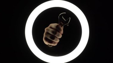 female hands hold adjustable spanner. adjustable wrench on a black background close-up. hand tool for repair. manual work.