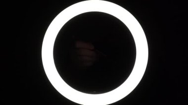 female hands hold a ballpoint pen with a cap close-up on a black background. Tool for blogger, student, copywriter, writer.