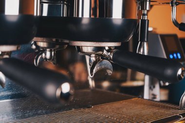 A close-up of the caf s coffee machine reveals its robust build, featuring sleek levers and steam wands, crafted for expert coffee preparation