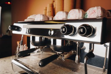 Close-up details of the professional coffee machine reveal a blend of modern technology and craftsmanship, central to the caf s vibrant atmosphere