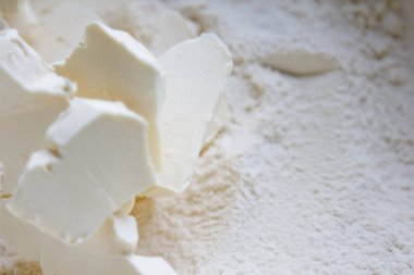 Preparation of shortbread. Flour and butter in a bowl on the table, top view. Close up