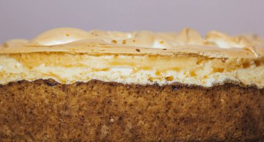 Orange cake on rustic wooden background, top view