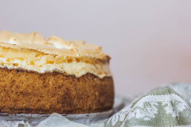 Delicious orange pie with zest and orange juice on a napkin on the table. Horizontal top view