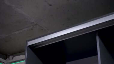 Gray wardrobe with open shelves, Compact and stylish, perfect for small city apartments