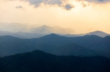 colorful dramatic sky with cloud at sunset. morning fog in dense tropical rainforest