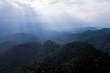 Top view Landscape of Morning Mist with Mountain Layer at north of Thailand. mountain ridge and clouds in rural jungle bush forest