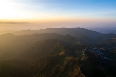 Top view Landscape of Morning Mist with Mountain Layer at north of Thailand. mountain ridge and clouds in rural jungle bush forest