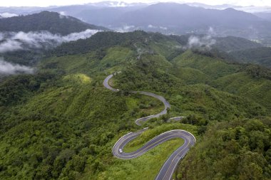Top view Landscape of Morning Mist with Mountain Layer at north of Thailand. mountain ridge and clouds in rural jungle bush forest