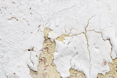 Alçı duvarın yüzeyinde beyaz boya kabuğu, grunge arkaplan veya doku