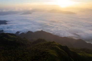 Landscape of Morning Mist with Mountain Layer at north of Thailand. mountain ridge and clouds in rural jungle bush forest
