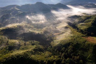 Landscape of Morning Mist with Mountain Layer at north of Thailand. mountain ridge and clouds in rural jungle bush forest