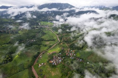 Landscape of Morning Mist with Mountain Layer at north of Thailand. mountain ridge and clouds in rural jungle bush forest
