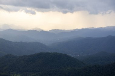 Landscape of Morning Mist with Mountain Layer at north of Thailand. mountain ridge and clouds in rural jungle bush forest