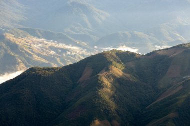 Landscape of Morning Mist with Mountain Layer at north of Thailand. mountain ridge and clouds in rural jungle bush forest