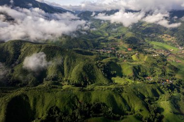 Landscape of Morning Mist with Mountain Layer at north of Thailand. mountain ridge and clouds in rural jungle bush forest
