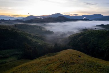 Landscape of Morning Mist with Mountain Layer at north of Thailand. mountain ridge and clouds in rural jungle bush forest