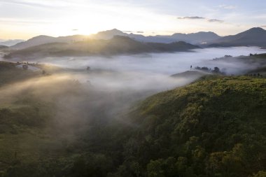 Landscape of Morning Mist with Mountain Layer at north of Thailand. mountain ridge and clouds in rural jungle bush forest