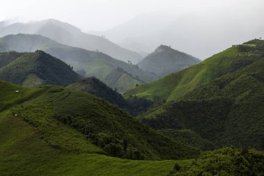Landscape of Morning Mist with Mountain Layer at north of Thailand. mountain ridge and clouds in rural jungle bush forest