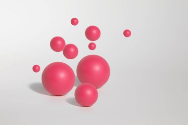 Beyaz arkaplandaki birkaç pembe kürenin, topların ya da parçacıkların kopyası.