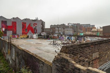 London, UK - Sep 24, 2013: An empty lot with huge graffiti, with the letters H W, in Hackney Wick, a district north of London