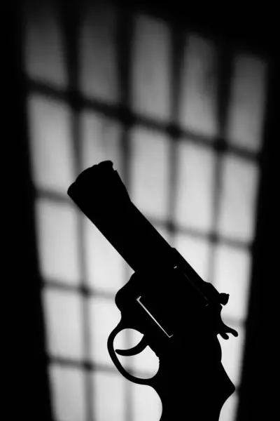 Pistol gun thriller book cover design photo with dramatic dark and light at night.