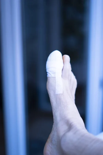 Foot big toe bandage injured feet in medical clinic hospital center.